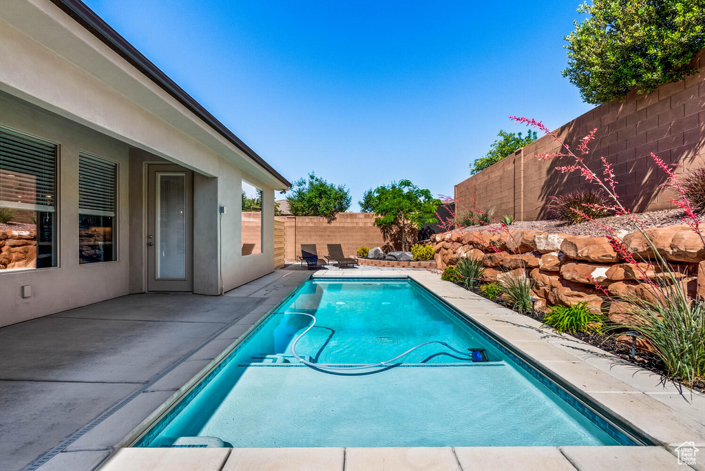 View of pool featuring a fenced backyard and a patio area