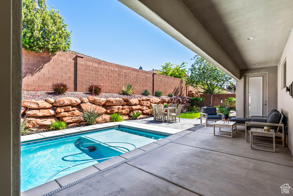 View of pool with a fenced backyard, a patio, and outdoor lounge area