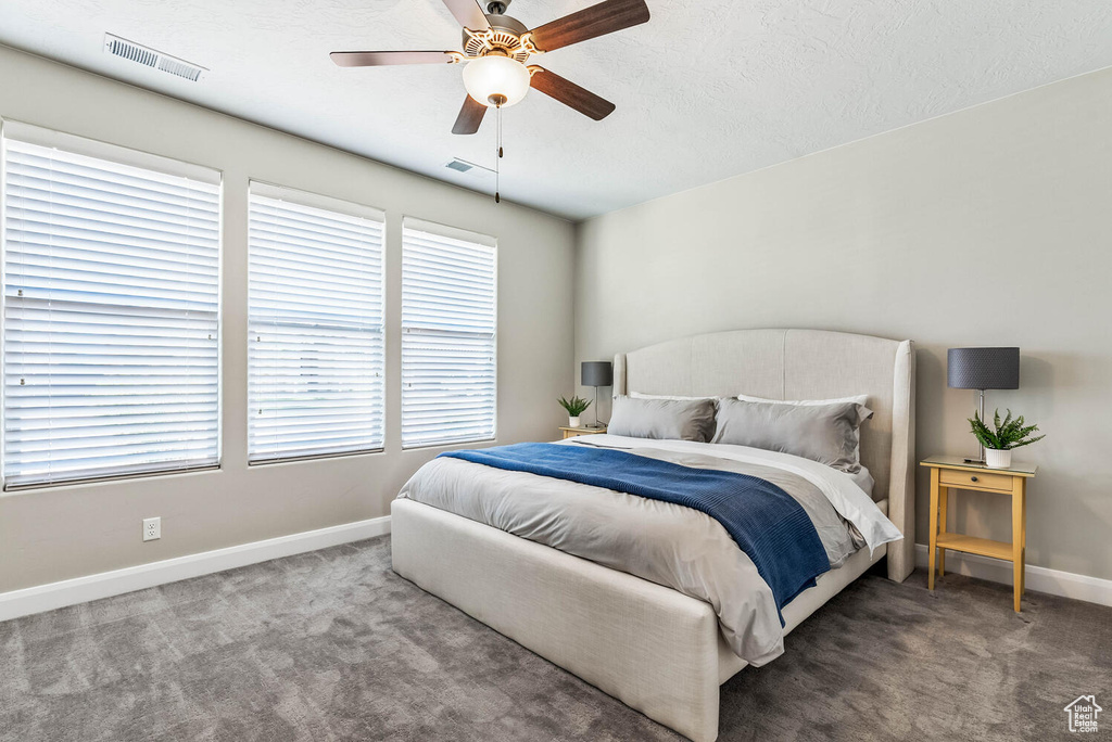 Bedroom with carpet flooring, baseboards, and ceiling fan