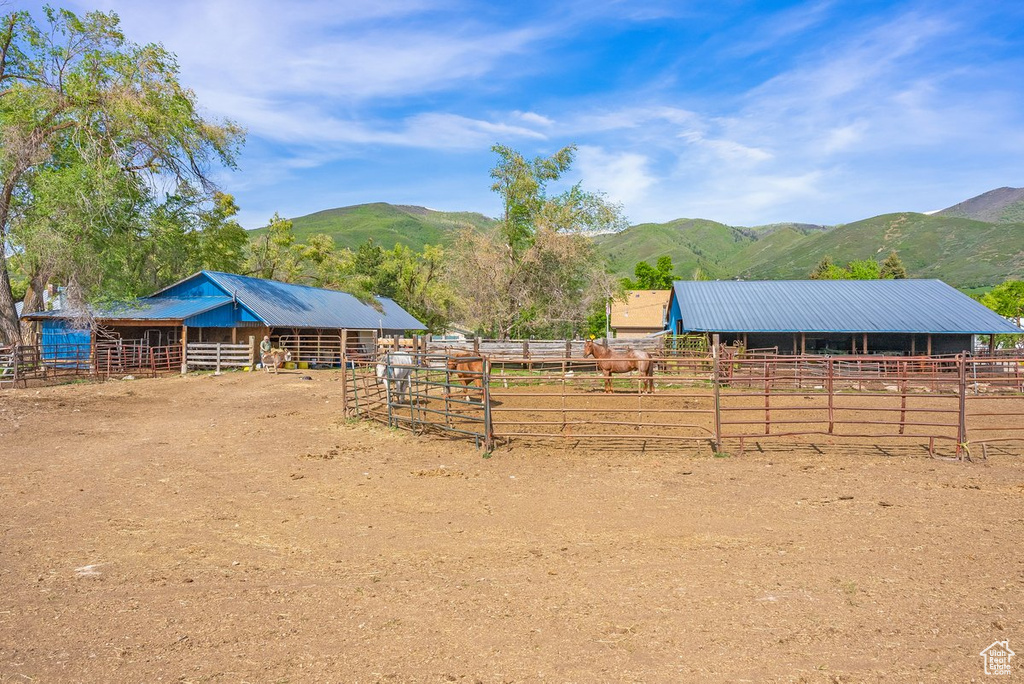 Stable featuring a mountain view and a view of countryside