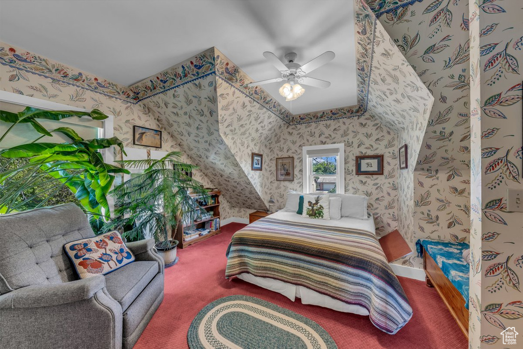 Carpeted bedroom with wallpapered walls and a ceiling fan