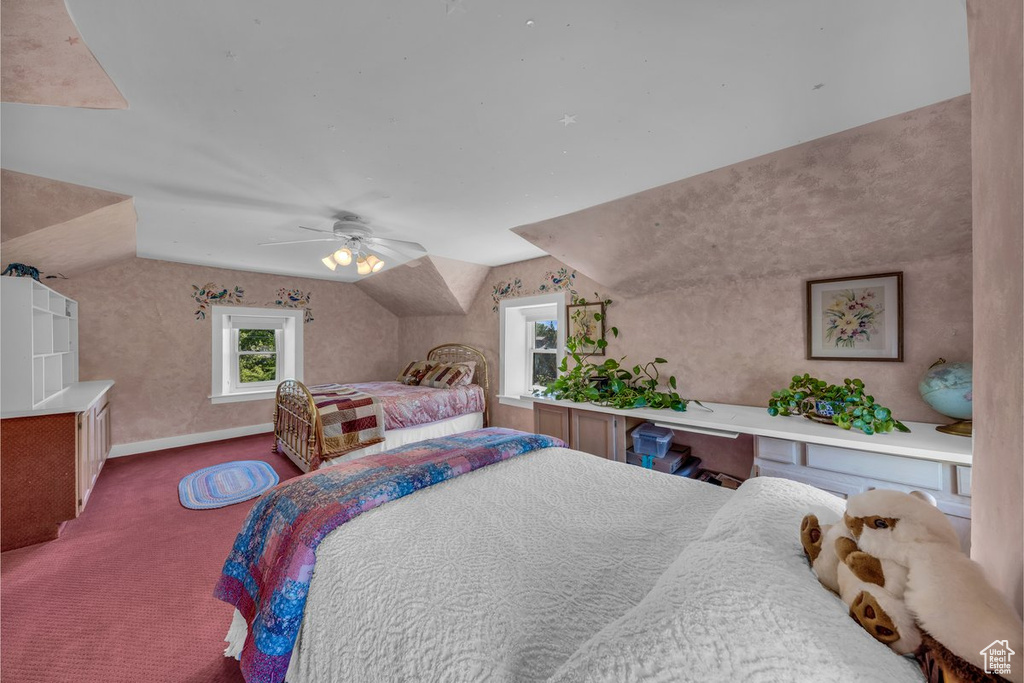 Bedroom with carpet floors, lofted ceiling, baseboards, and ceiling fan
