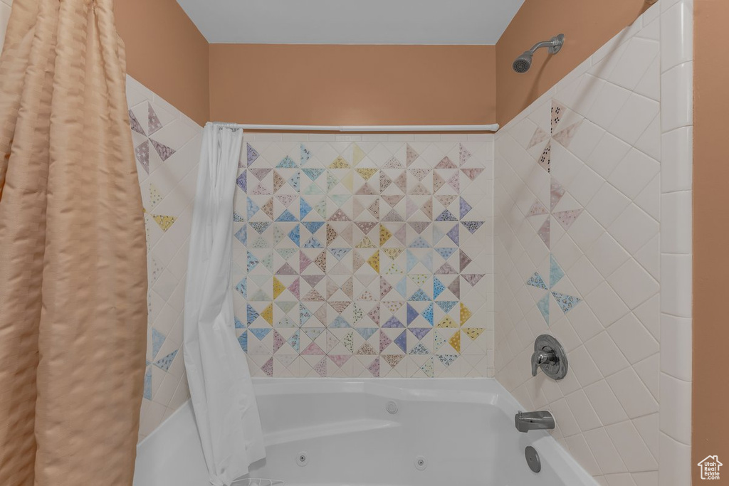 Full bathroom featuring shower / bathtub combination with curtain