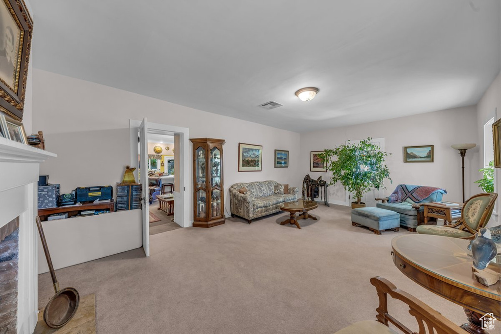 Carpeted living room with a fireplace