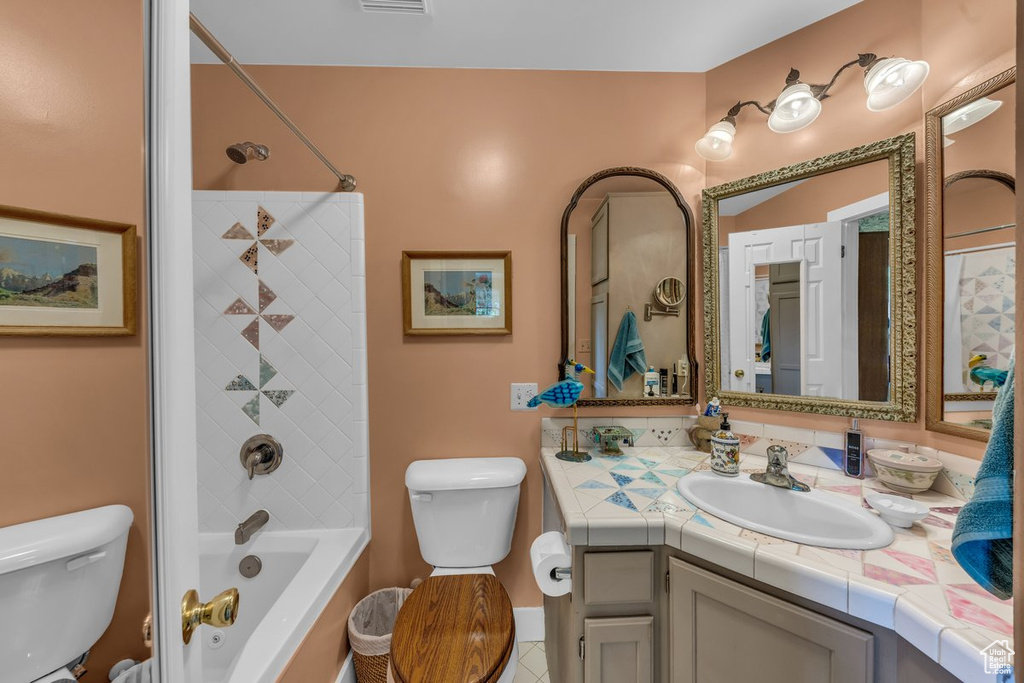 Full bathroom with toilet, vanity, bathing tub / shower combination, and tile patterned floors