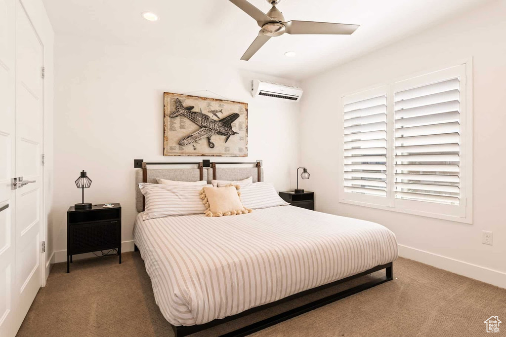 Carpeted bedroom with an AC wall unit, baseboards, recessed lighting, and ceiling fan
