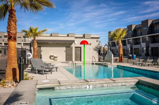 Community pool featuring fence and a patio area