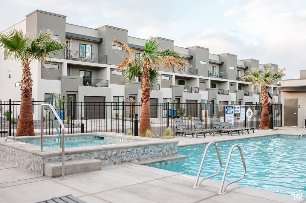 Community pool with fence and a community hot tub