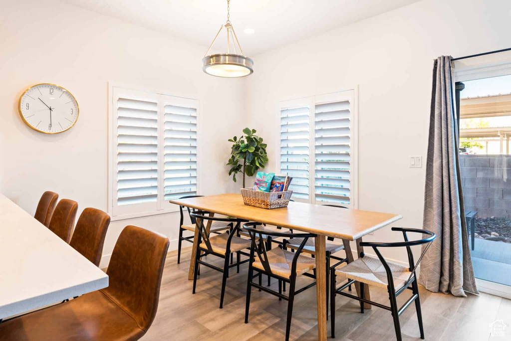 Dining room with light wood finished floors and baseboards