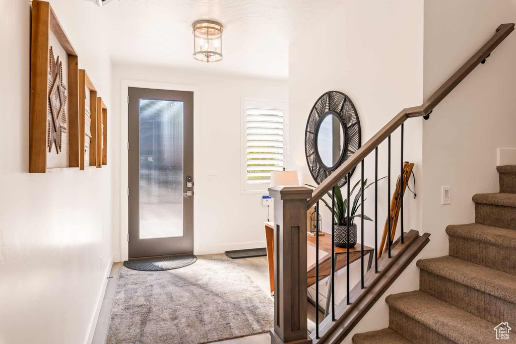 Entrance foyer with stairway and baseboards