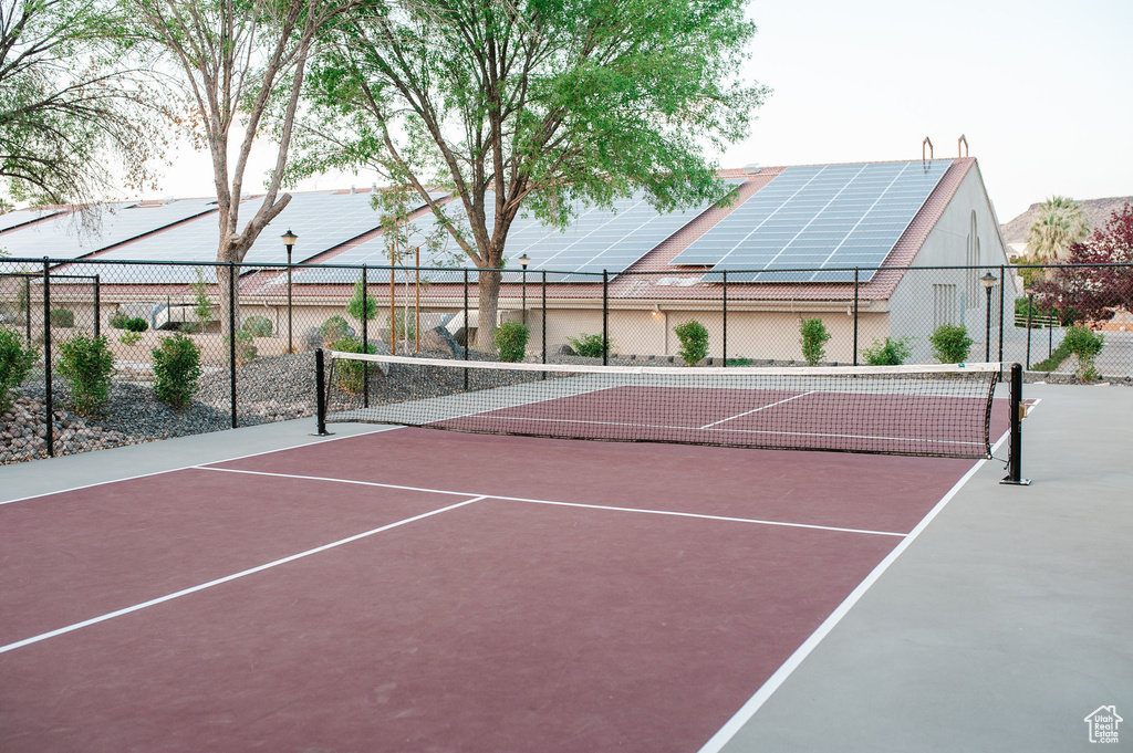 View of tennis court featuring fence