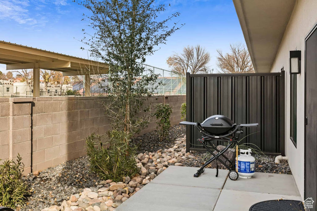 View of patio featuring fence