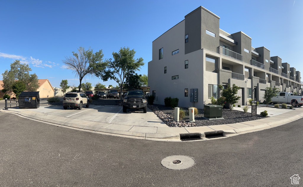 View of property with uncovered parking