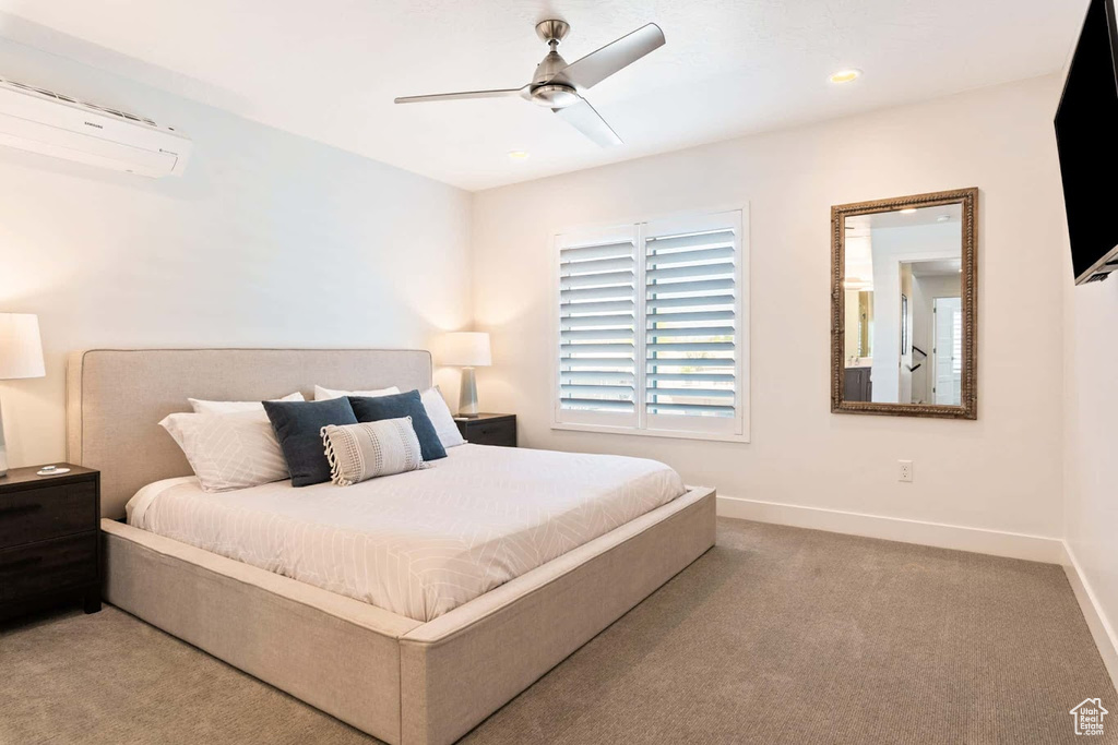 Bedroom featuring a wall mounted air conditioner, carpet, baseboards, and recessed lighting