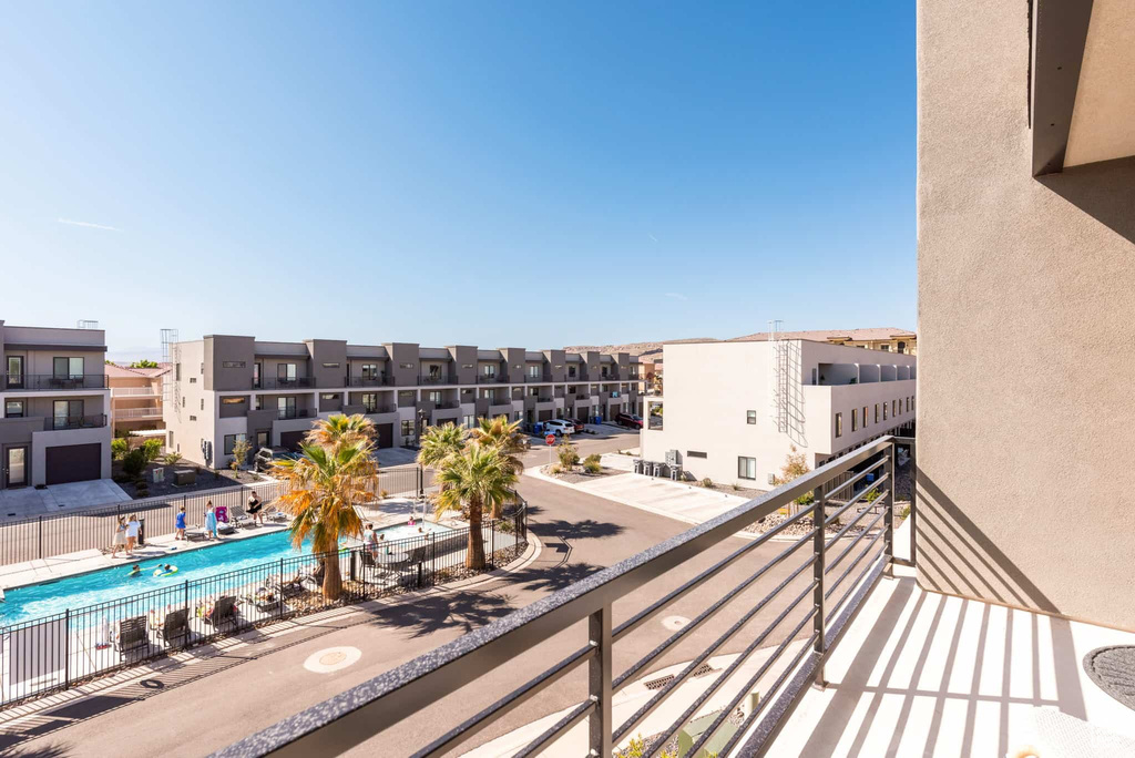 Balcony featuring view of pool