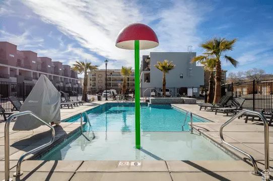 Community pool with fence and a patio