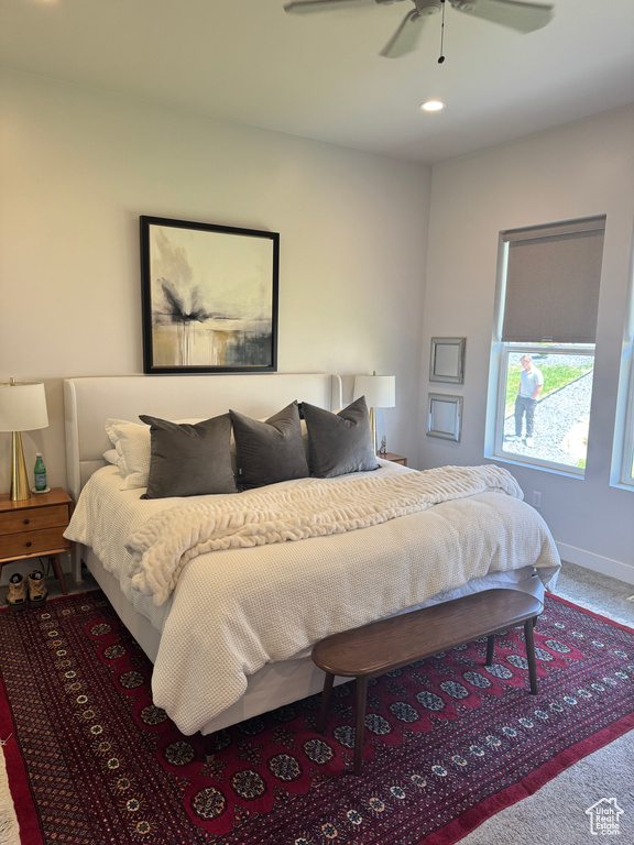 Carpeted bedroom with baseboards and ceiling fan