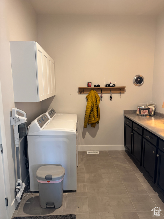 Laundry area featuring cabinet space, independent washer and dryer, and baseboards