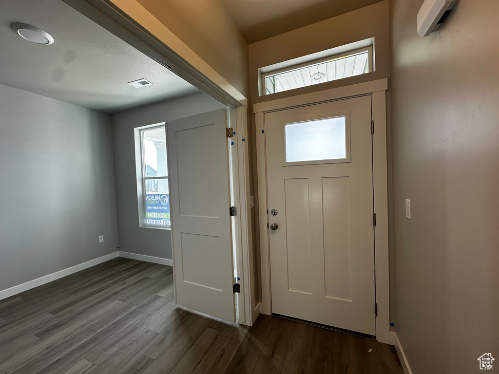 Entrance foyer featuring dark wood-style flooring and baseboards