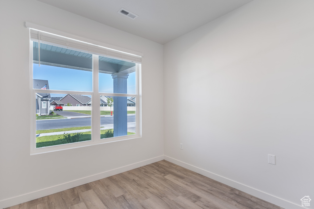 Unfurnished room with baseboards and light wood-style flooring