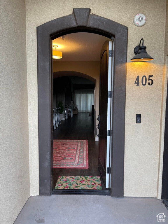 Doorway to property featuring stucco siding