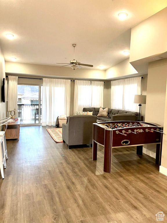 Recreation room with baseboards, ceiling fan, and wood finished floors