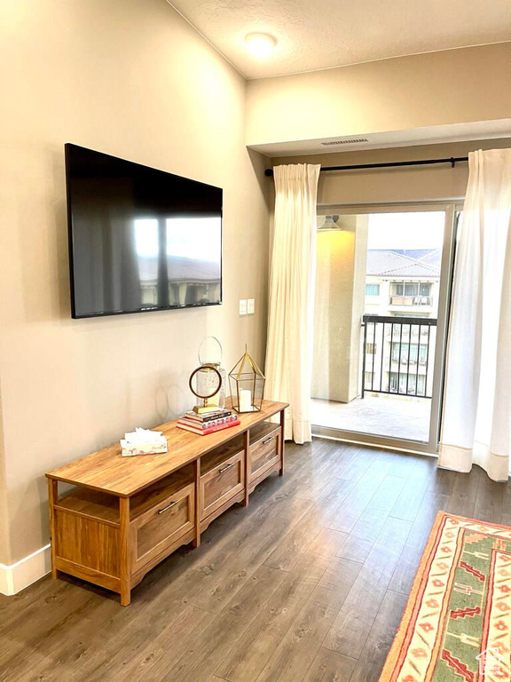 Doorway to outside featuring baseboards and wood finished floors