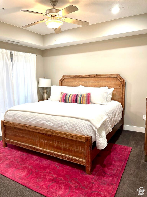 Bedroom with carpet, baseboards, and a ceiling fan