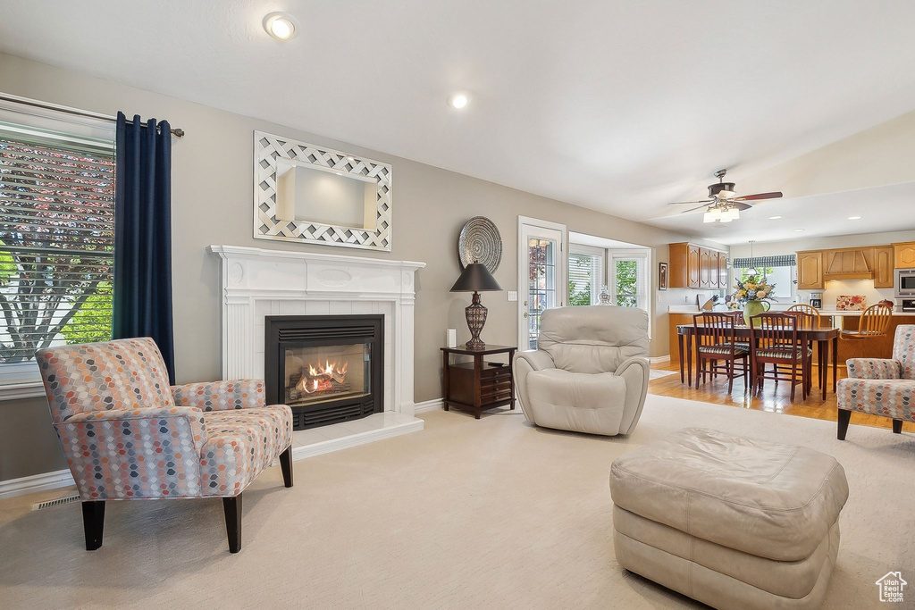 Living room featuring a tile fireplace, a ceiling fan, recessed lighting, and baseboards