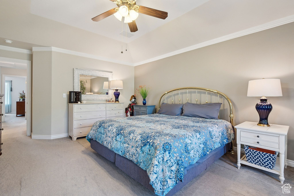 Bedroom with carpet flooring, baseboards, crown molding, and a ceiling fan