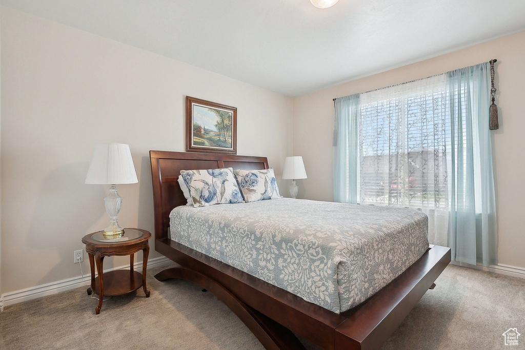 Bedroom with carpet floors and baseboards