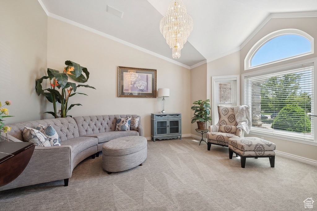 Carpeted living area featuring vaulted ceiling, a chandelier, baseboards, and ornamental molding