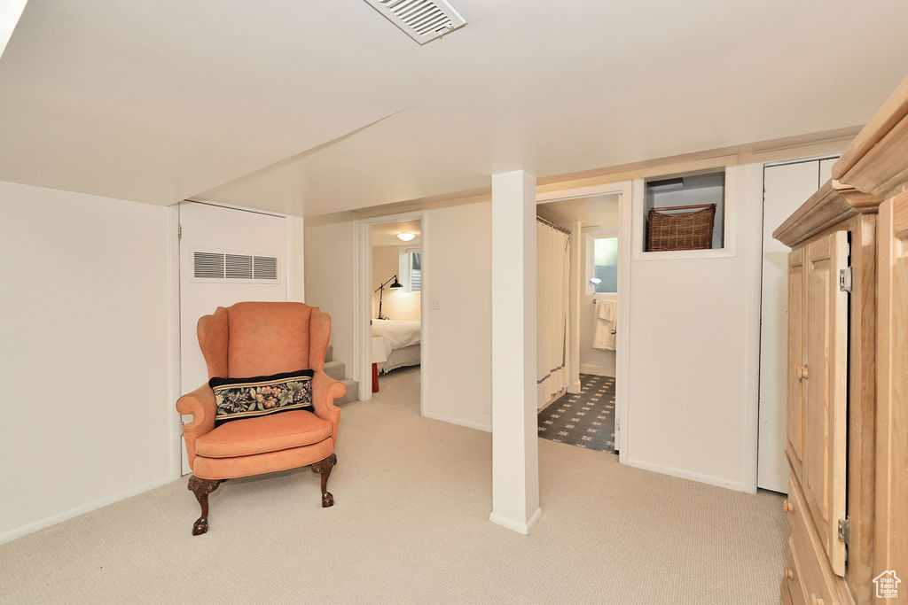 Sitting room with light carpet and baseboards