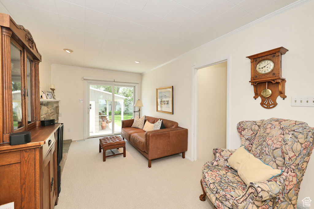 Living room featuring light colored carpet, crown molding, and recessed lighting
