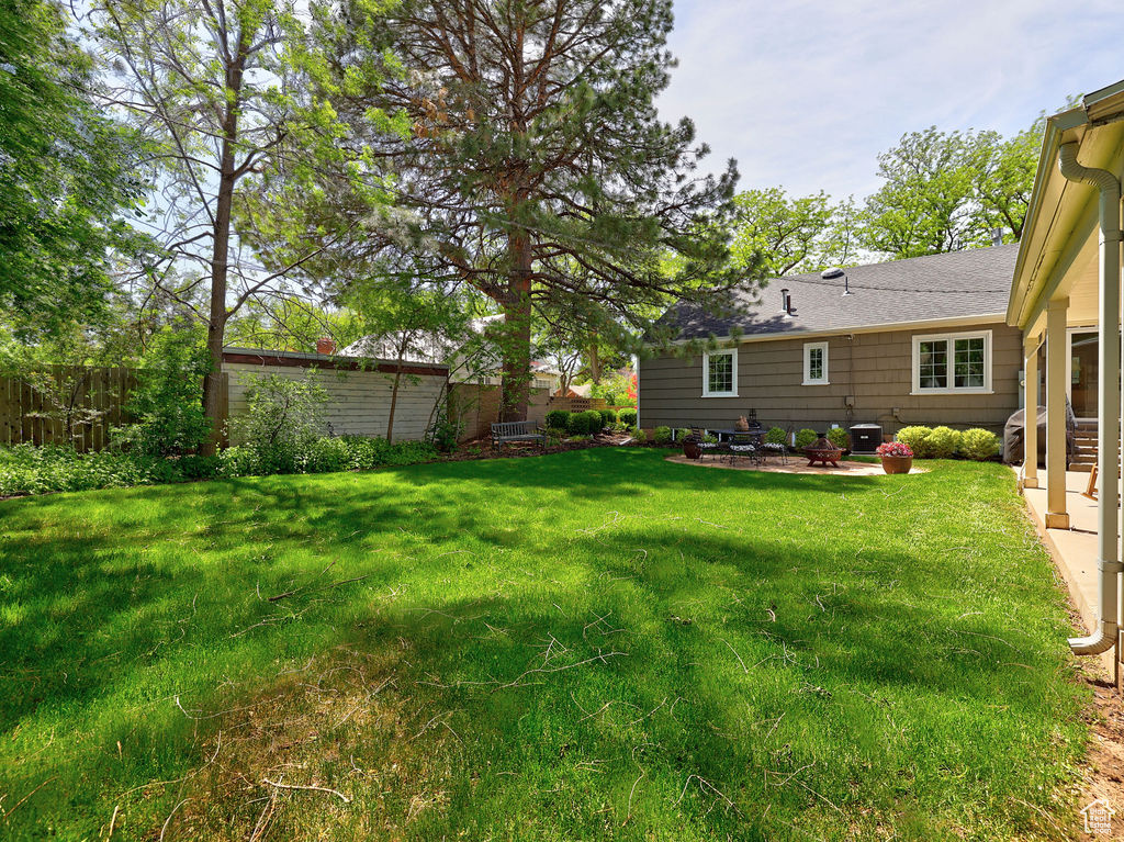 View of yard with a patio and cooling unit