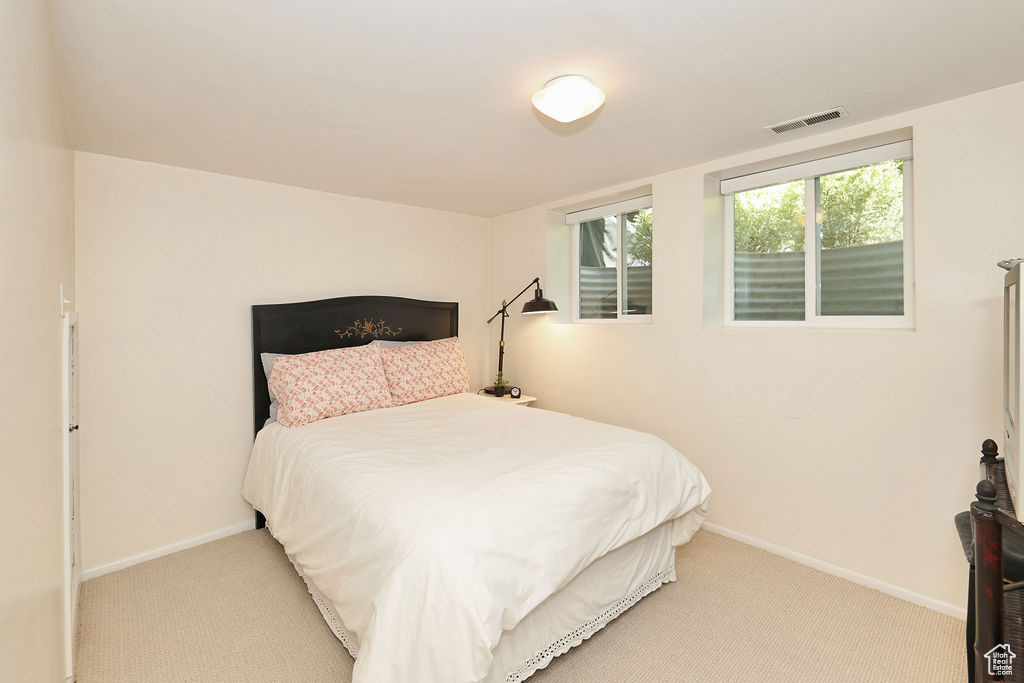 Carpeted bedroom featuring baseboards