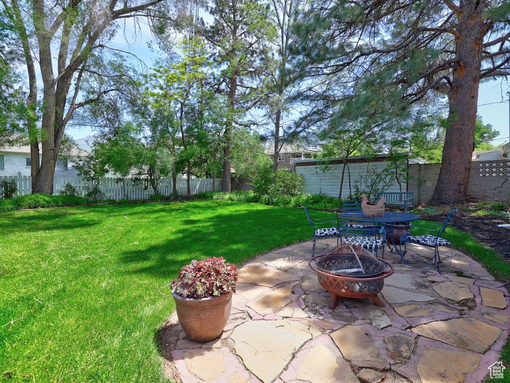 View of yard with a fire pit and a patio area