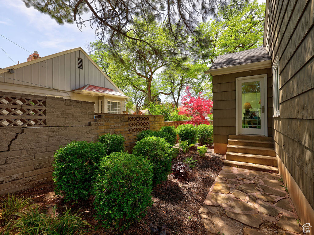View of yard featuring entry steps and fence