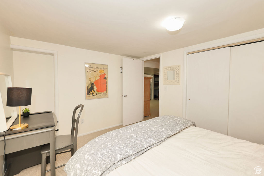 Bedroom with a closet, carpet floors, and baseboards