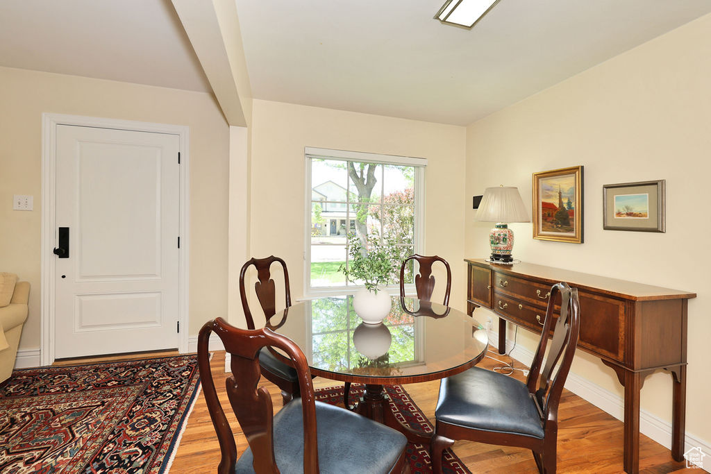 Dining room with light wood-type flooring and baseboards
