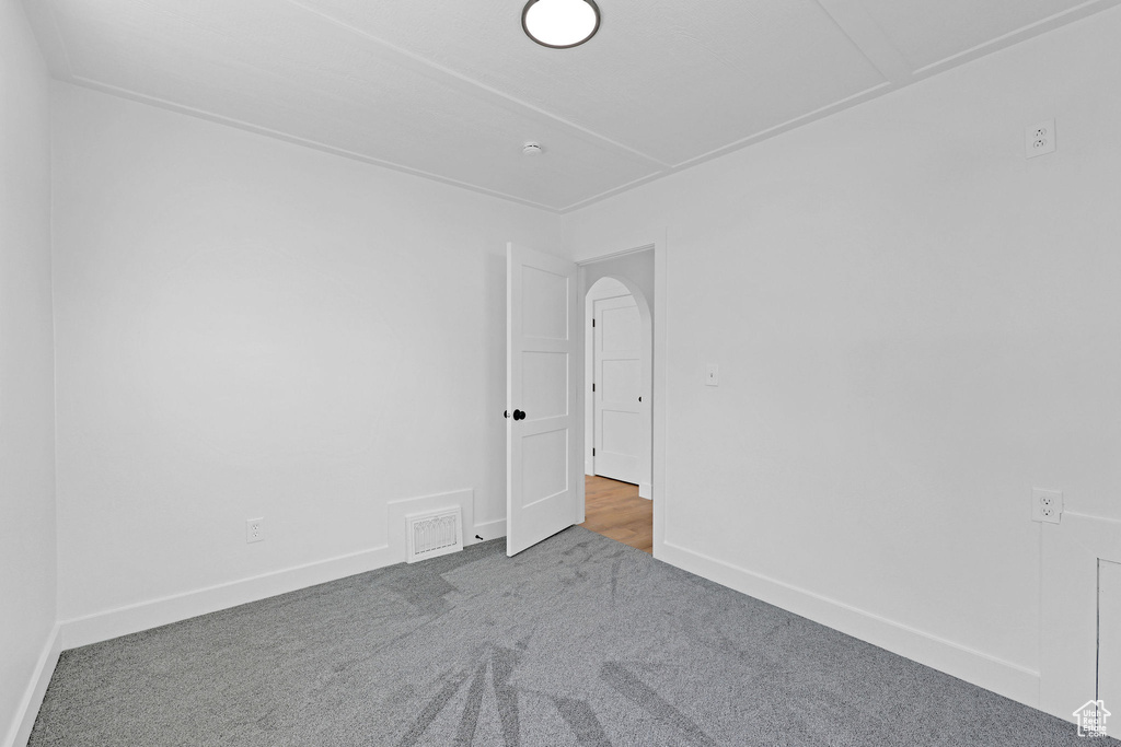 Carpeted spare room with baseboards