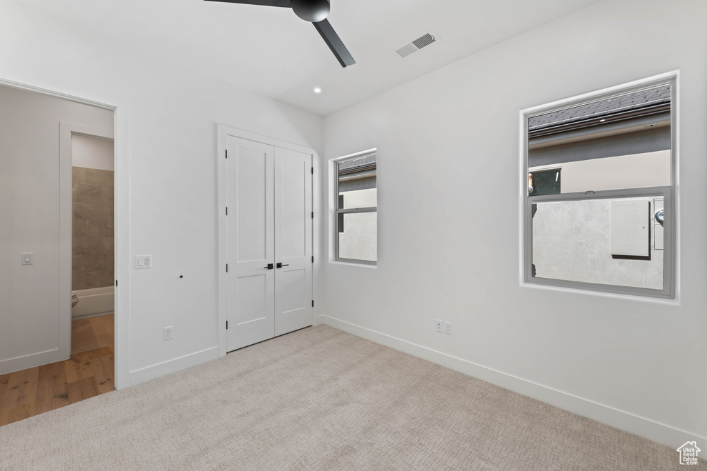 Unfurnished bedroom featuring carpet floors, baseboards, a closet, and a ceiling fan