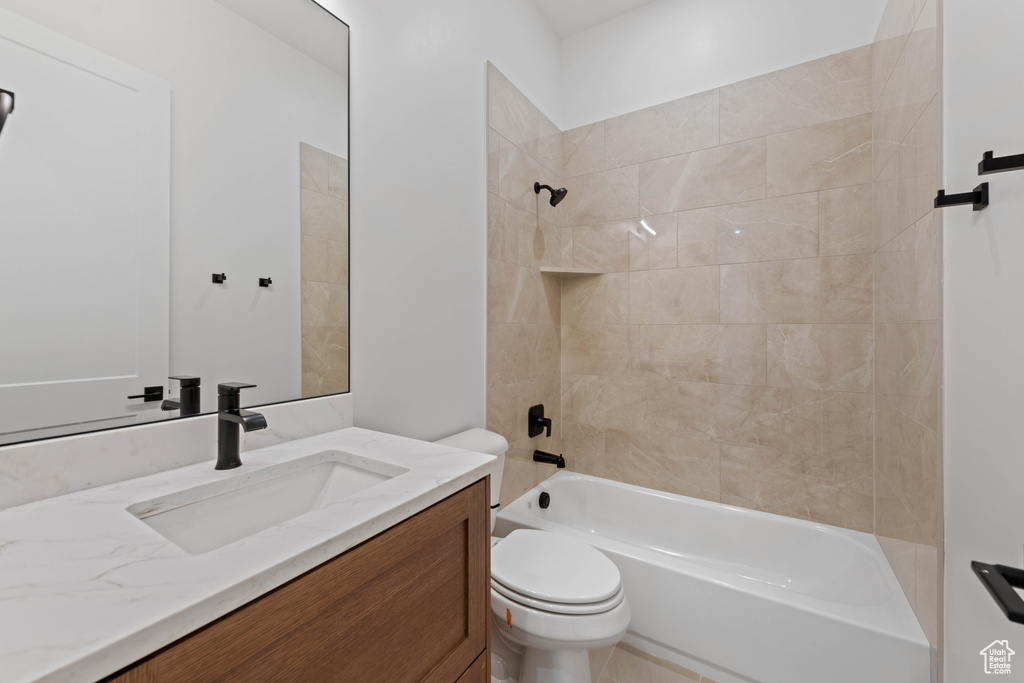 Bathroom with toilet, shower / washtub combination, and vanity