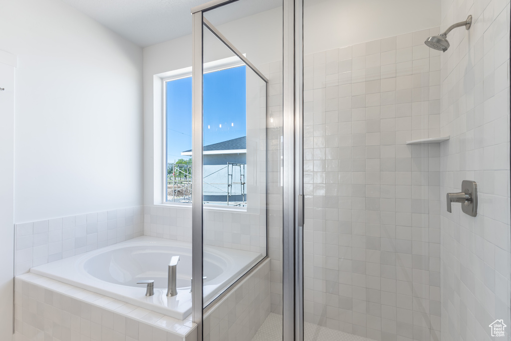 Full bathroom with a stall shower and a bath