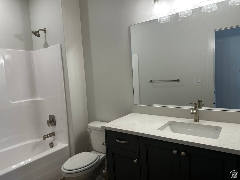 Bathroom with toilet, vanity, and bathing tub / shower combination