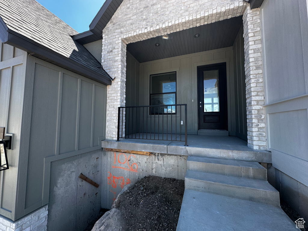 Doorway to property featuring a porch and board and batten siding