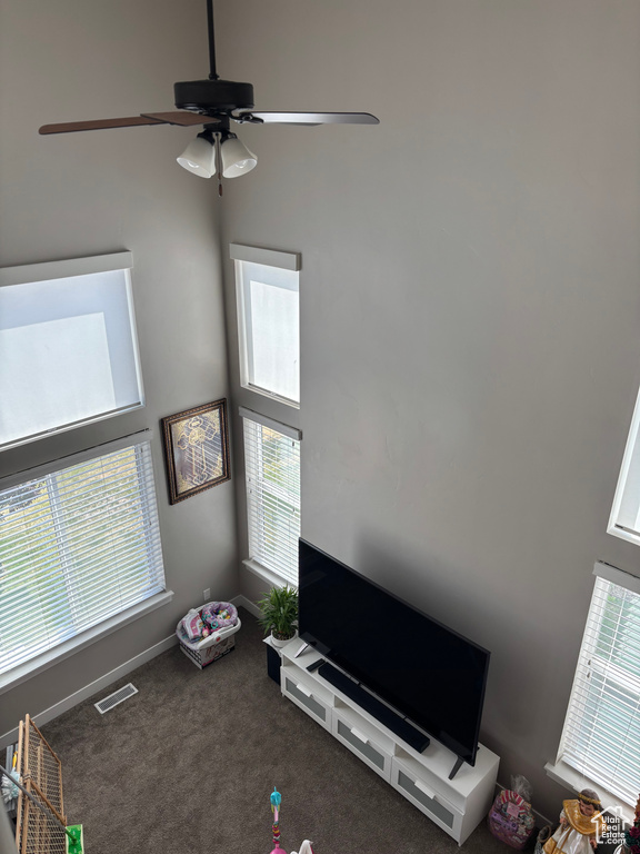 Playroom with ceiling fan, carpet floors, and baseboards
