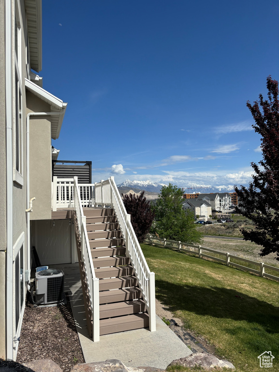 View of yard with central air condition unit and stairway