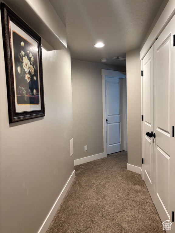 Hallway featuring carpet flooring, baseboards, and recessed lighting