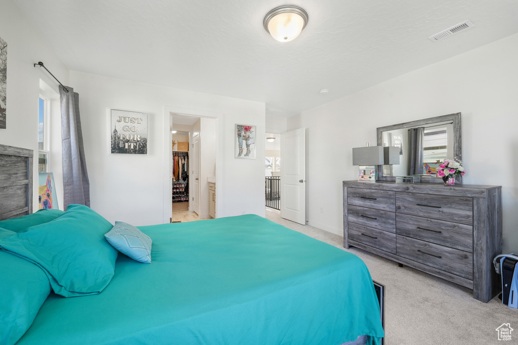 Carpeted bedroom with multiple windows